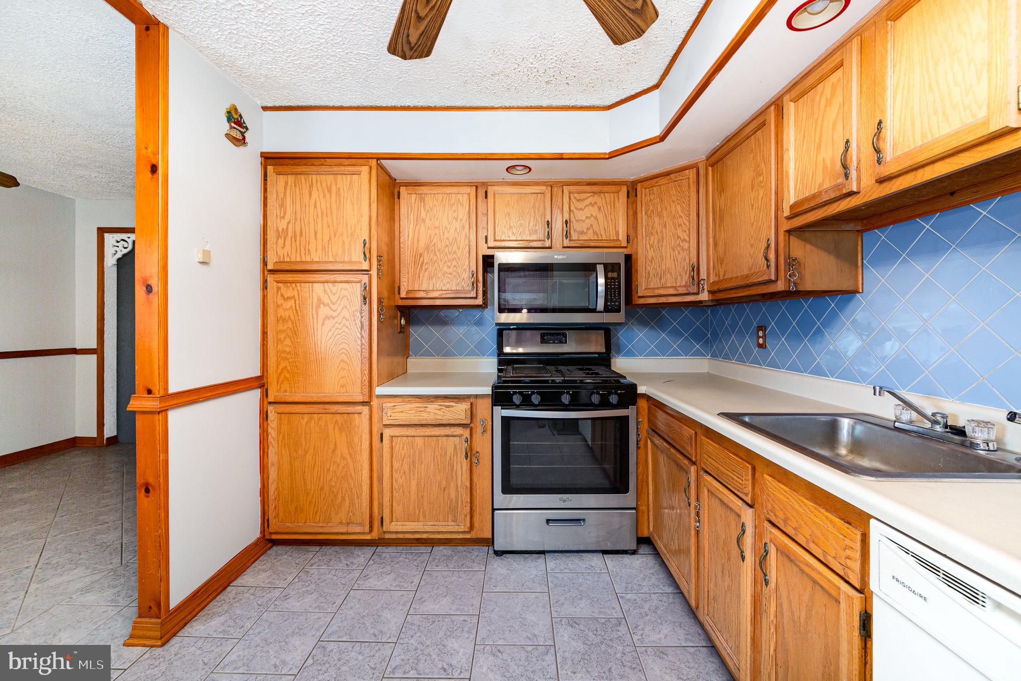 8226 North Boundary Road Baltimore, MD 21222 - Photo 13 of 37 a kitchen with stainless steel appliances granite countertop a refrigerator a stove and a sink