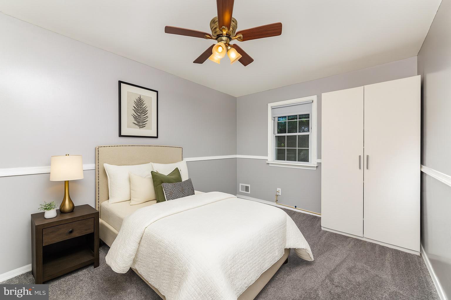 8226 North Boundary Road Baltimore, MD 21222 - Photo 19 of 37 a bedroom with a bed and a chandelier