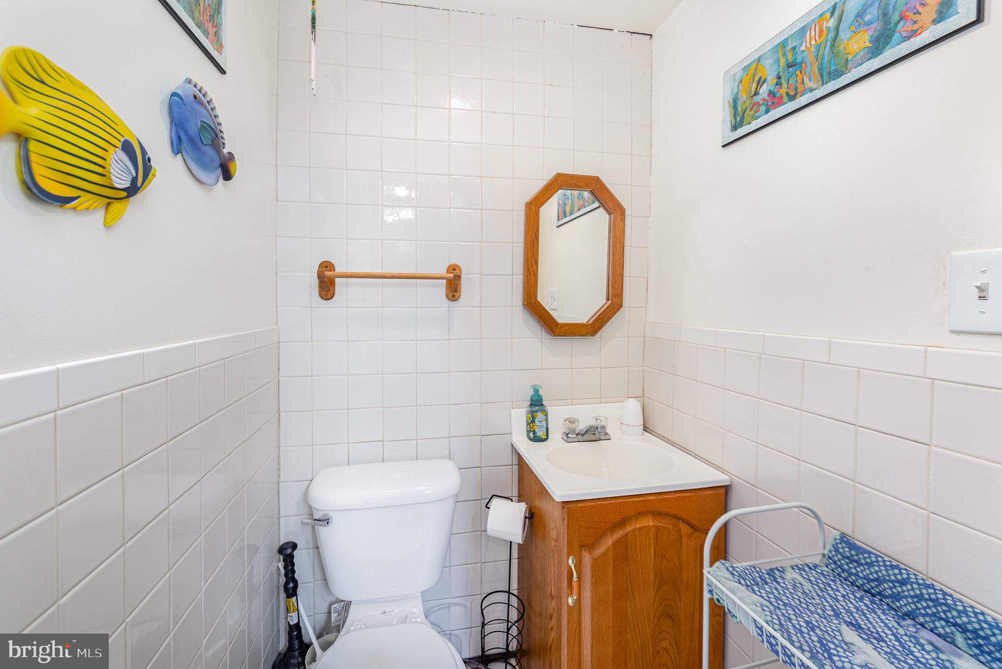 8226 North Boundary Road Baltimore, MD 21222 - Photo 28 of 37 a bathroom with a sink a toilet and a mirror
