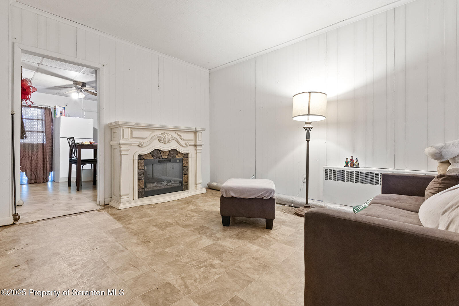 1008 Mt Vernon Avenue Scranton, PA 18508 - Photo 4 of 12 a living room with furniture a fireplace and a chandelier