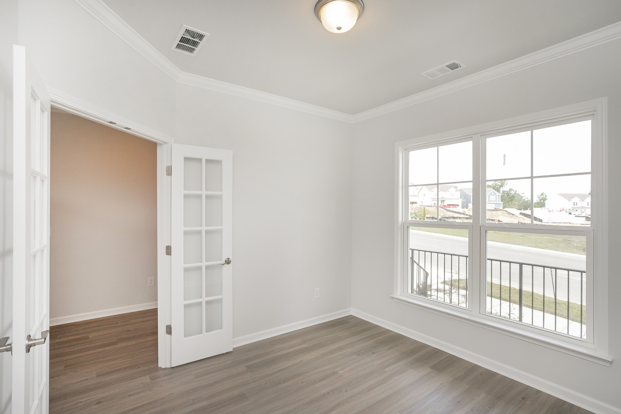 486 Jet Strm Drive La Vergne, TN 37086 - Photo 10 of 27 an empty room with wooden floor and windows