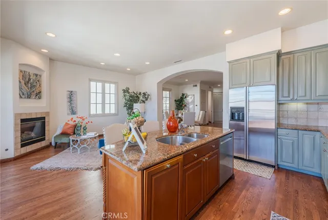 a kitchen with a sink stove and wooden cabinets