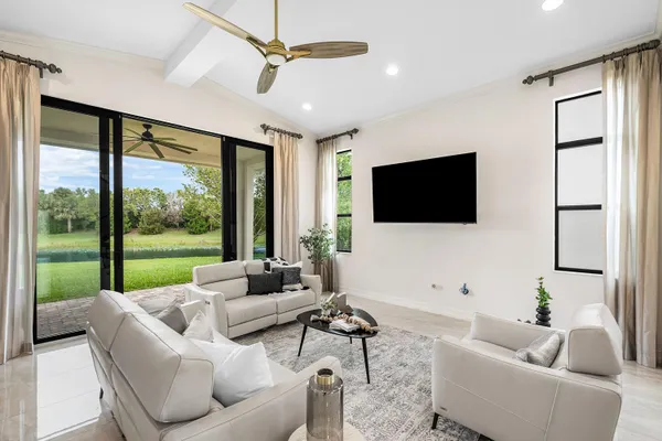 a living room with furniture and a potted plant