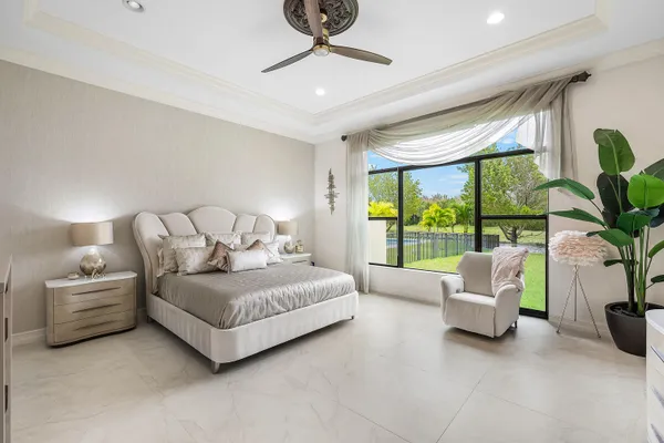 a living room with furniture flat screen tv and a large window
