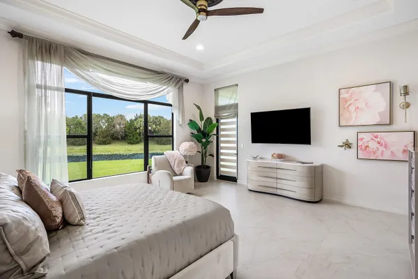 a bedroom with furniture and a flat screen tv