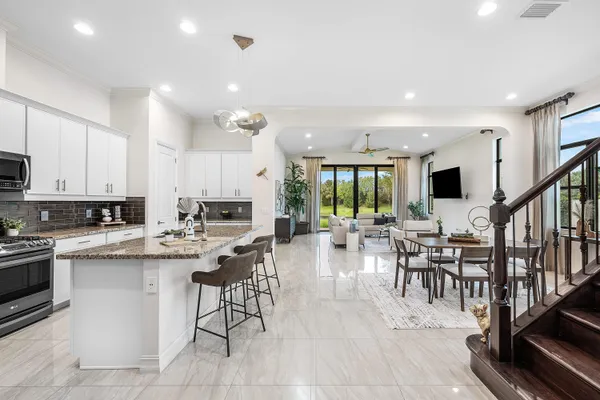 a kitchen with stainless steel appliances granite countertop a sink stove and refrigerator