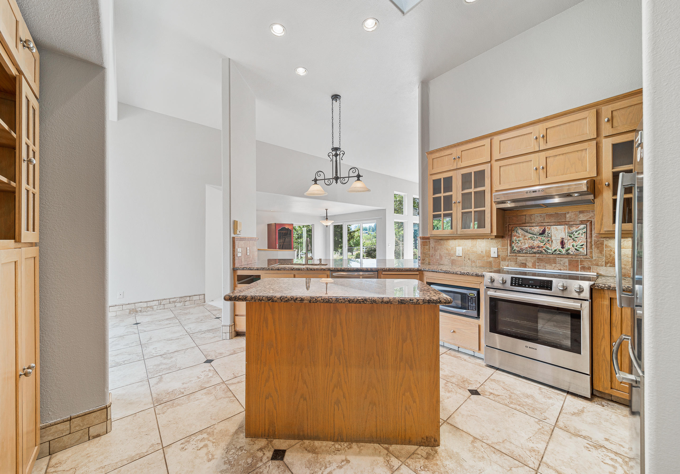 925 Anderson Creek Road Talent, OR 97540 - Photo 6 of 52 a kitchen with kitchen island stainless steel appliances a stove a sink and a refrigerator