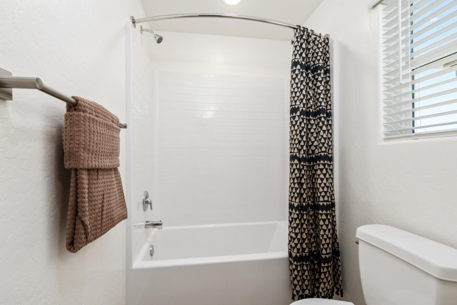 1502 Redbrick Lane Clovis, CA 93619 - Photo 21 of 33 a bathroom with a bathtub and shower