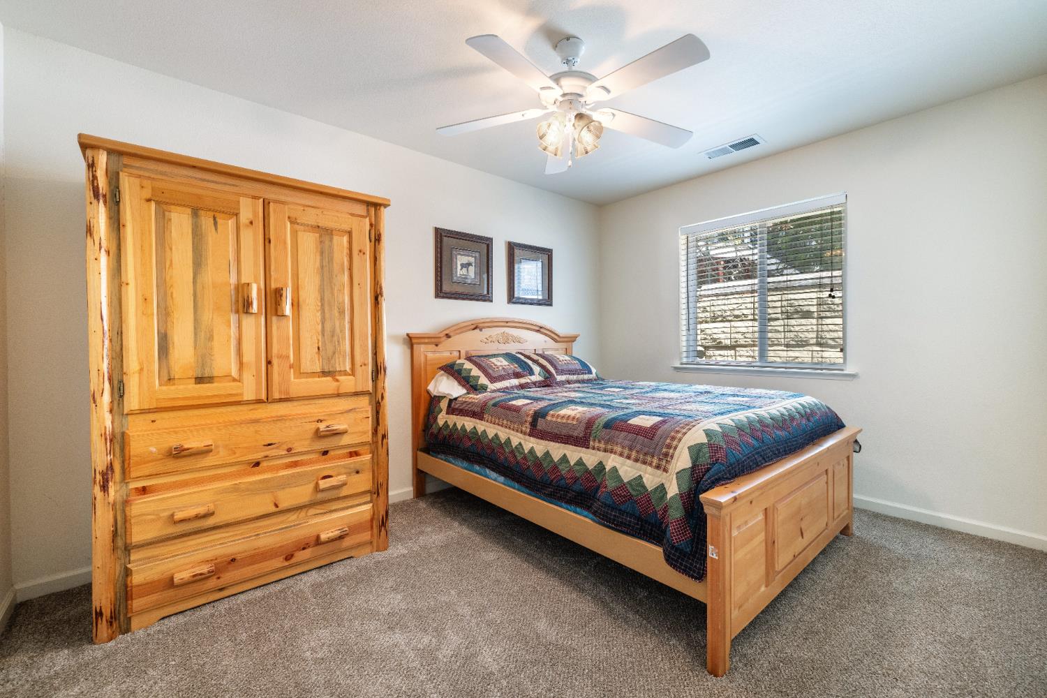 39398 Robin Bass Lake, CA 93604 - Photo 22 of 31 a bedroom with a bed and a chandelier