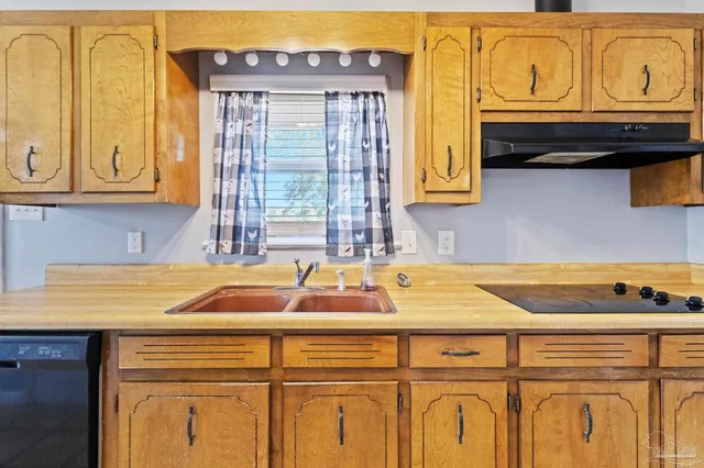 a kitchen with stainless steel appliances granite countertop a sink and cabinets