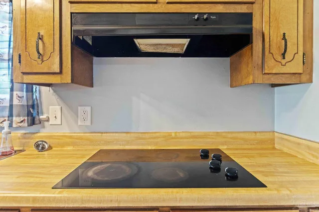 a view of a kitchen with a stove top oven
