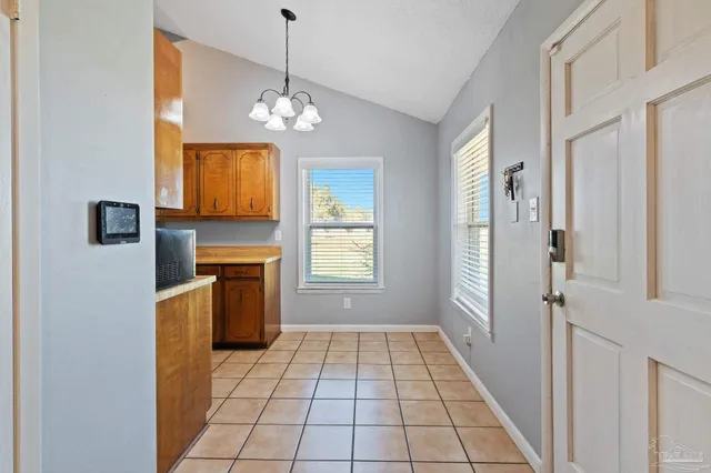 an empty room with wooden floor fan and window