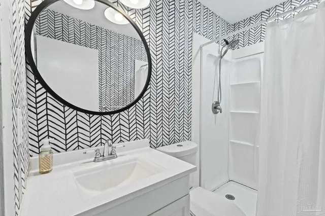 a bathroom with a shower and a curtain