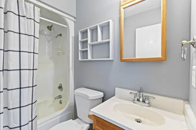 an empty room with a window and chandelier fan