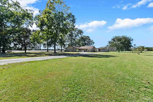 a front view of house with yard and green space