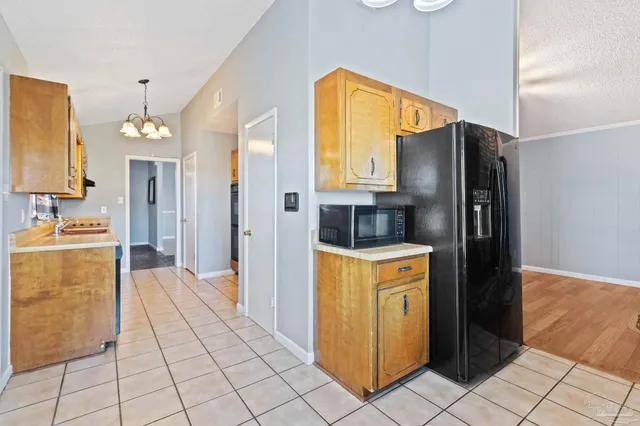 a kitchen with stainless steel appliances granite countertop a refrigerator and a stove