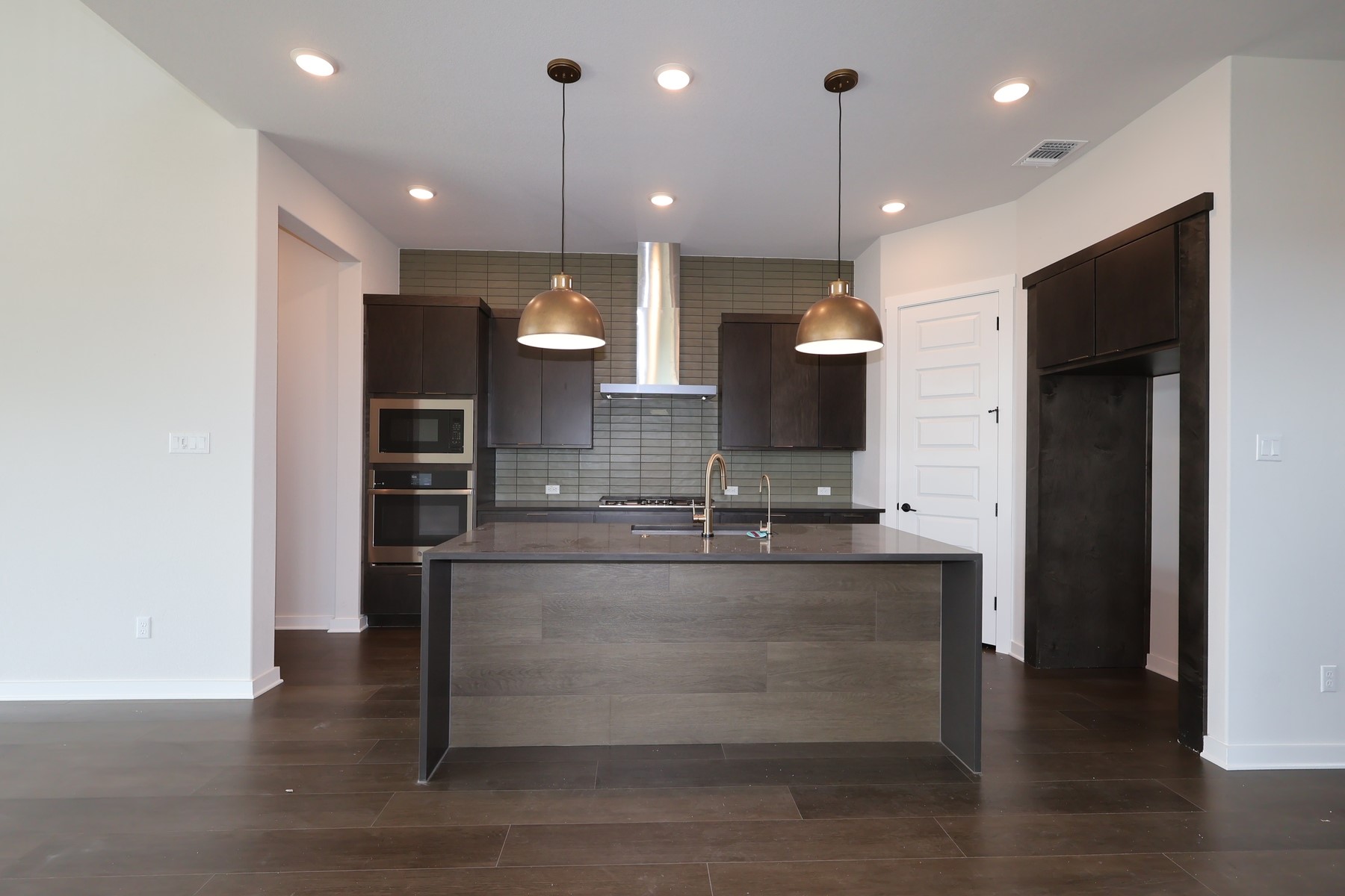 436 Leaning Rock Road Georgetown, TX 78628 - Photo 6 of 22 a large kitchen with a large counter top space appliances and a ceiling fan