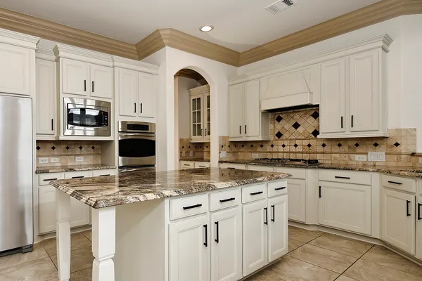 a kitchen with stainless steel appliances granite countertop a sink and cabinets
