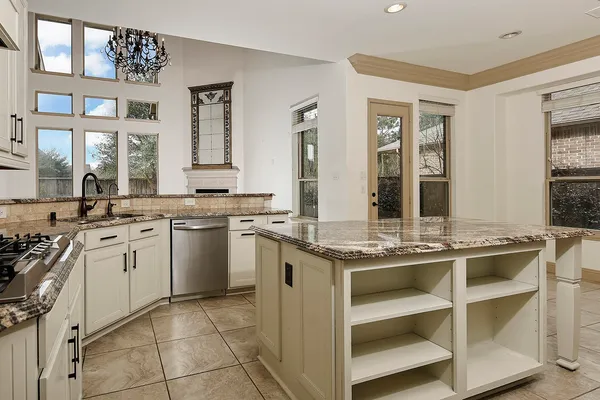 a kitchen with a sink stove and cabinets