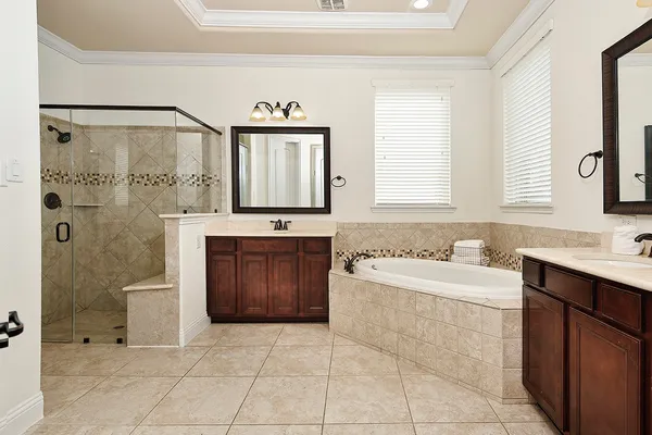 a spacious bathroom with a bathtub sink and mirror