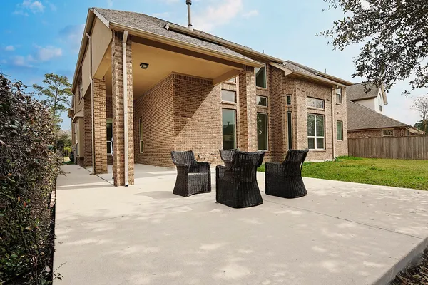 a view of a patio with table and chairs and wooden fence