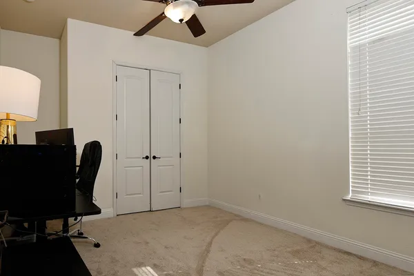 a view of a workspace with furniture and a window