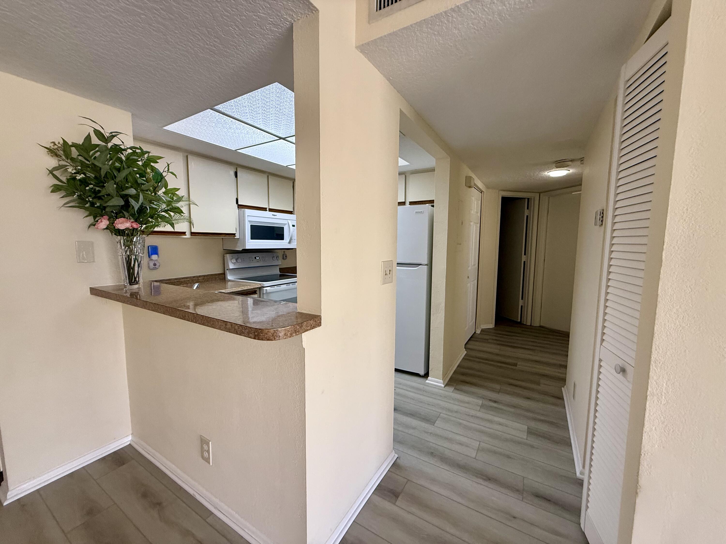 a kitchen view with a refrigerator and a sink