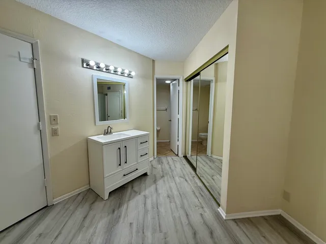 a bathroom with a sink a mirror and a shower