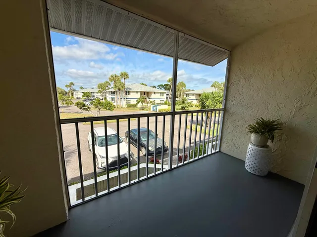 a view of a balcony with furniture