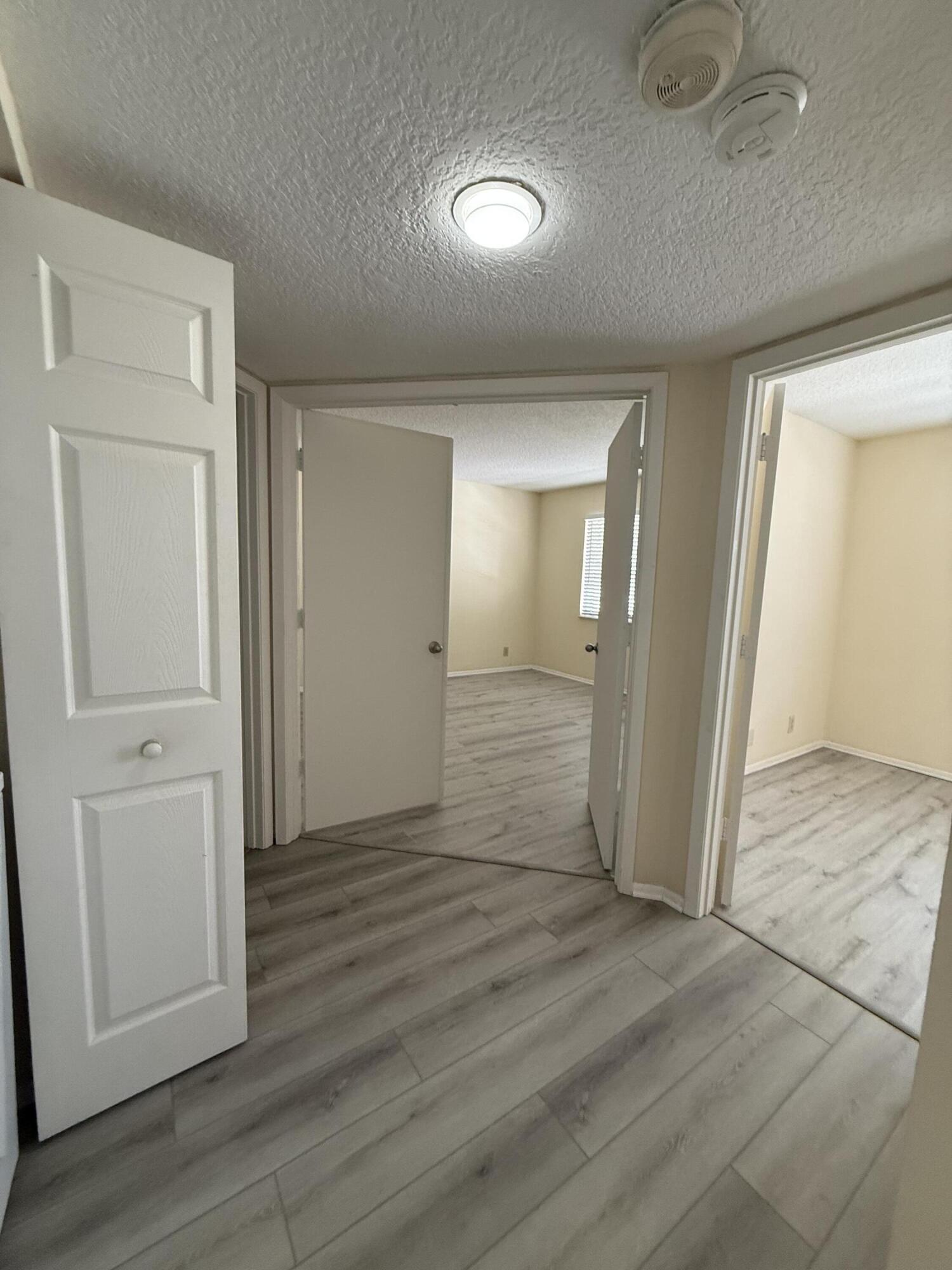 1520 Southeast Royal Green Circle, Unit K 205 Port St. Lucie, FL 34952 - Photo 4 of 18 wooden floor in an empty room