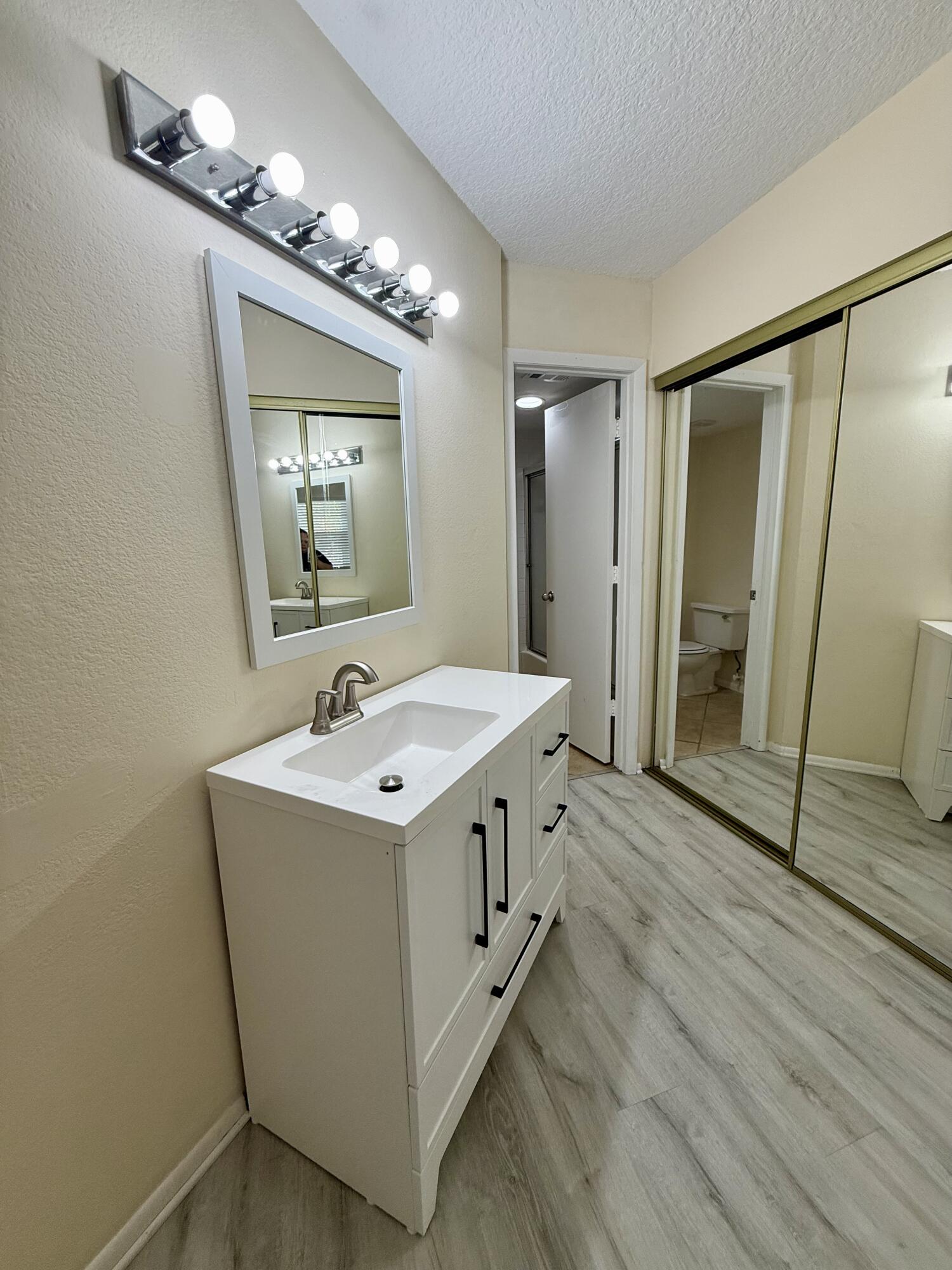 1520 Southeast Royal Green Circle, Unit K 205 Port St. Lucie, FL 34952 - Photo 9 of 18 a view of a bathroom sink and mirror