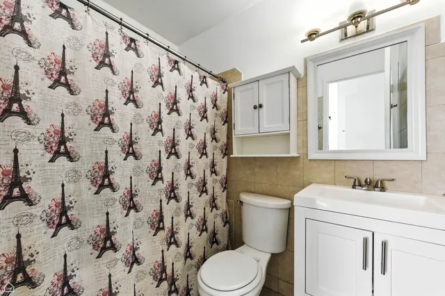 a bathroom with a sink toilet and mirror