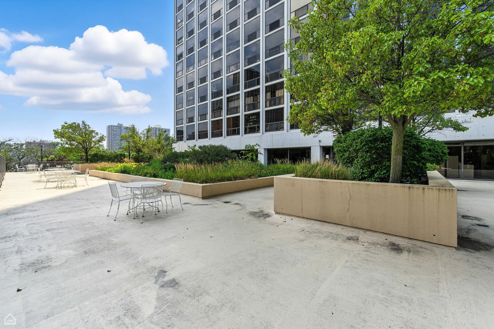 4343 North Clarendon Avenue, Unit 2317 Chicago, IL 60613 - Photo 19 of 20 a view of a building and trees in the background