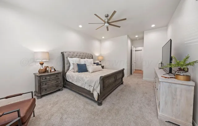 a bed room with a bed and a potted plant