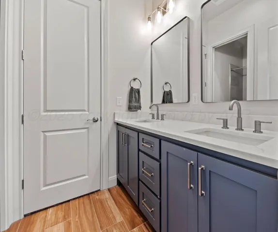 a bathroom with a double vanity sink and mirror