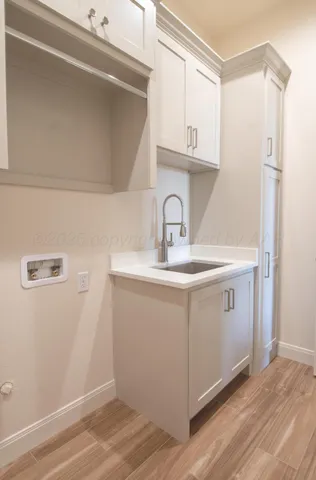 a utility room with cabinets washer and dryer