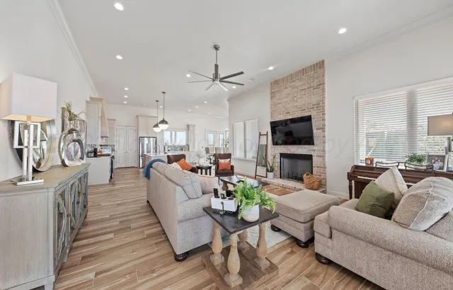 a living room with furniture a flat screen tv and a fireplace