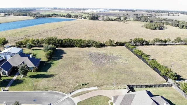 an aerial view of residential houses with outdoor space and ocean view