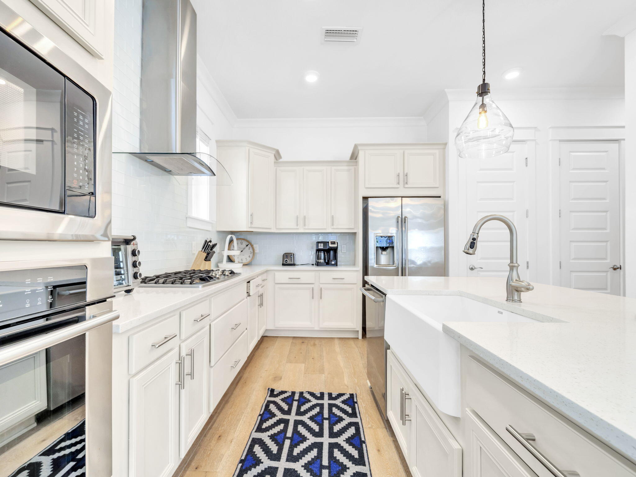 282 Milestone Dr Inlet Beach, Unit B Inlet Beach, FL 32461 - Photo 11 of 42 a large kitchen with stainless steel appliances granite countertop a sink and cabinets with wooden floor