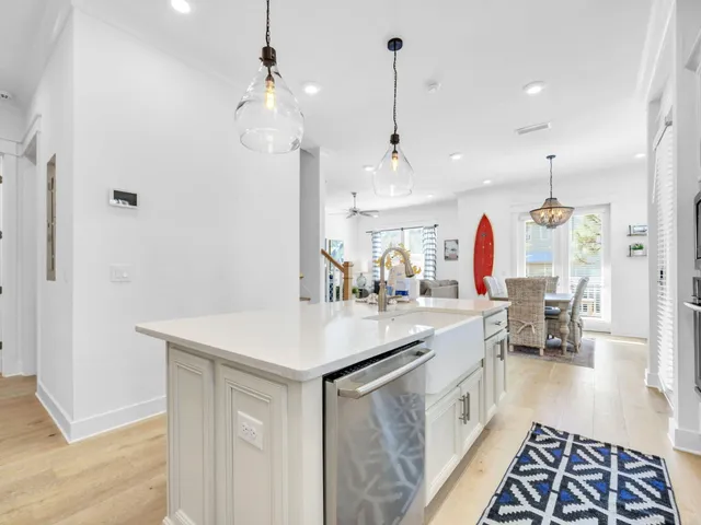 a kitchen with kitchen island a sink stove and refrigerator