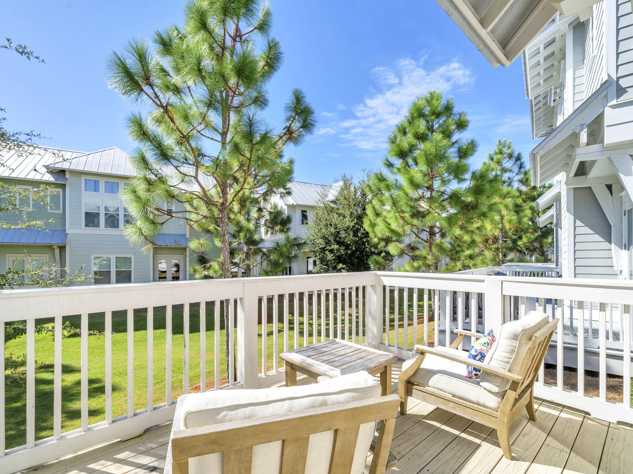 282 Milestone Dr Inlet Beach, Unit B Inlet Beach, FL 32461 - Photo 19 of 42 a view of a chair and table in the balcony