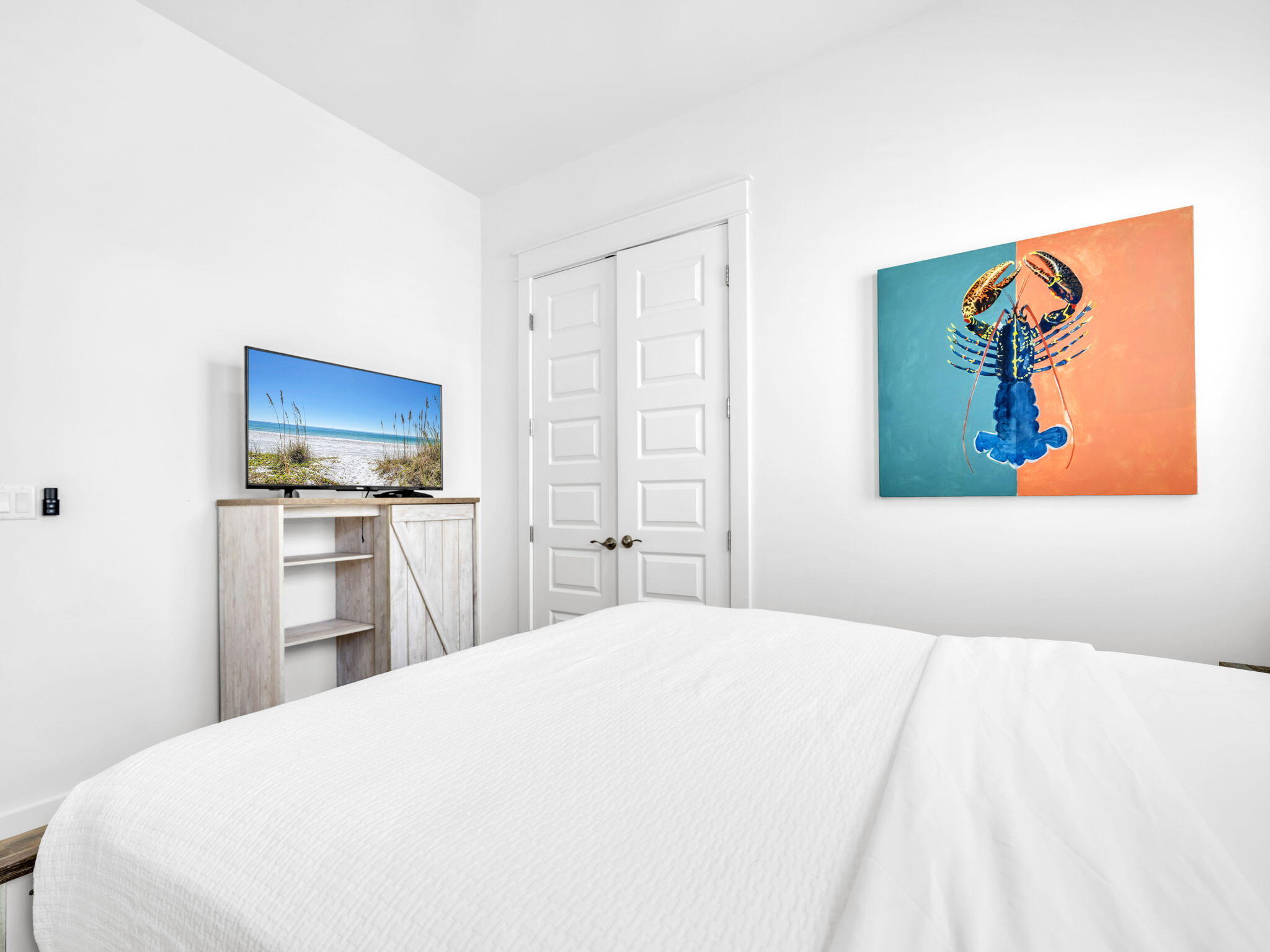 282 Milestone Dr Inlet Beach, Unit B Inlet Beach, FL 32461 - Photo 26 of 42 a bedroom with a bed and a television