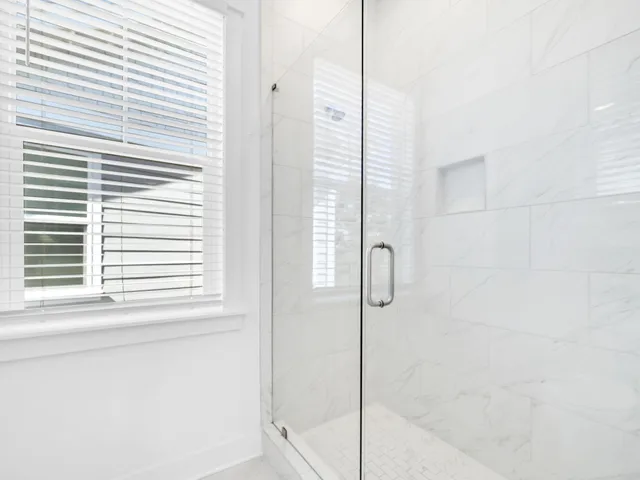 a bathroom with a glass shower door