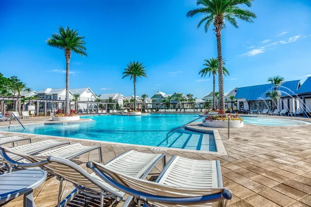 a view of swimming pool with a table and chairs
