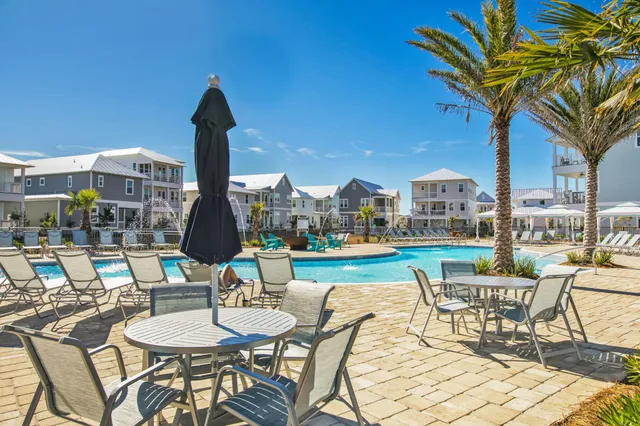 a view of a chairs and table in patio with a lake view