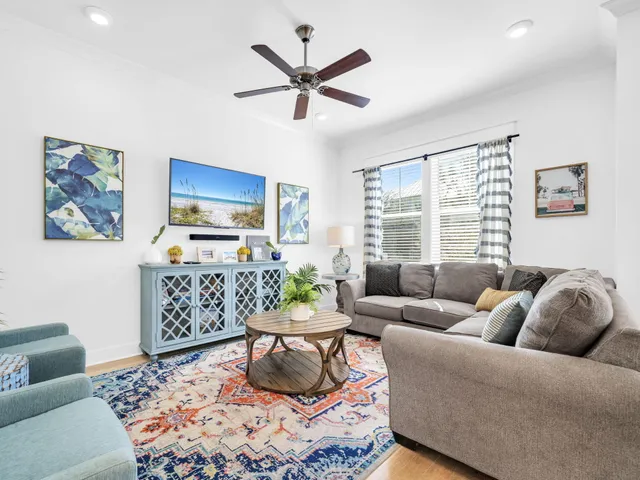 a living room with furniture ceiling fan and a window