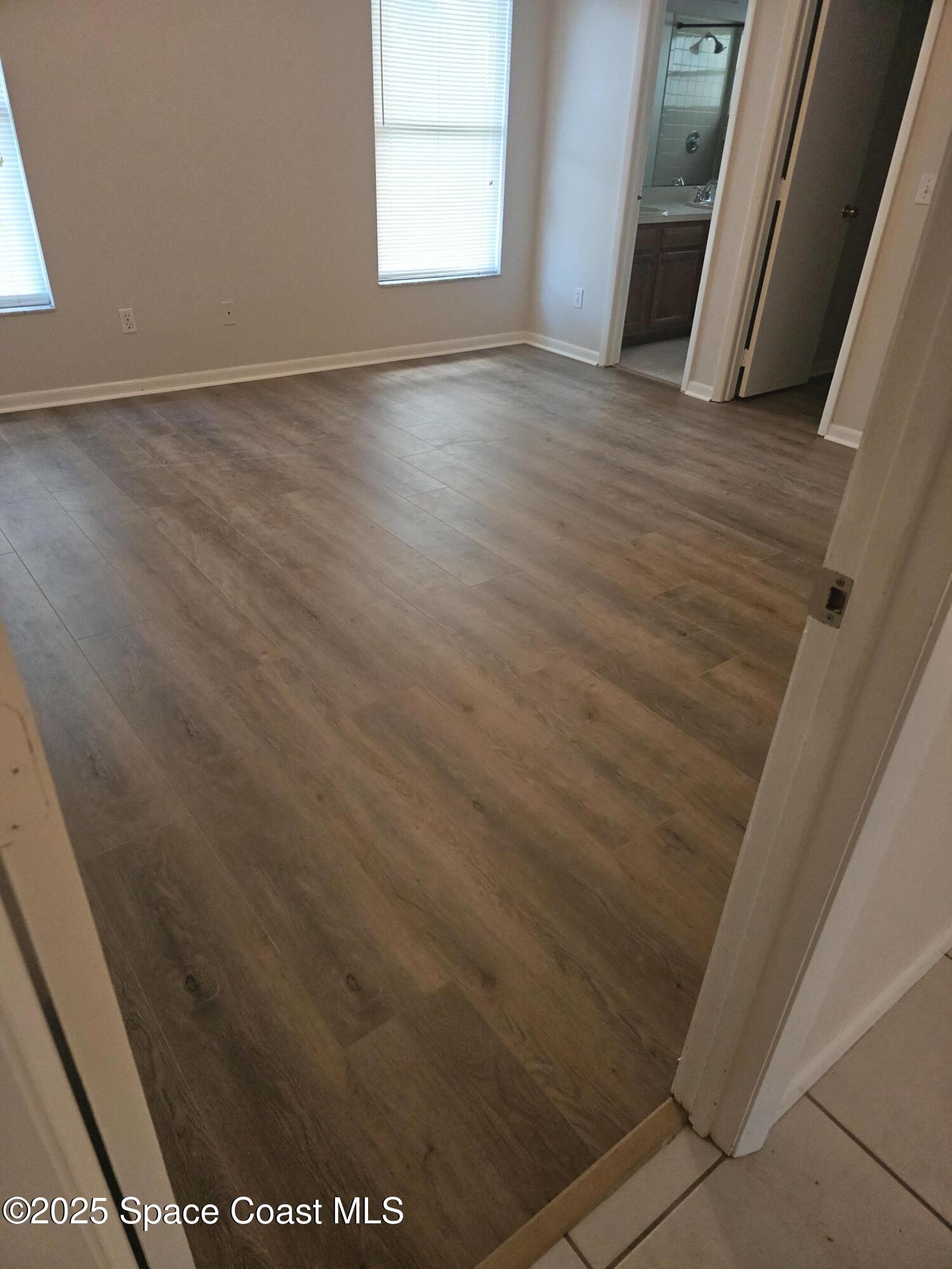 4533 Rivermist Drive Melbourne, FL 32935 - Photo 12 of 14 a view of an empty room with wooden floor and a window