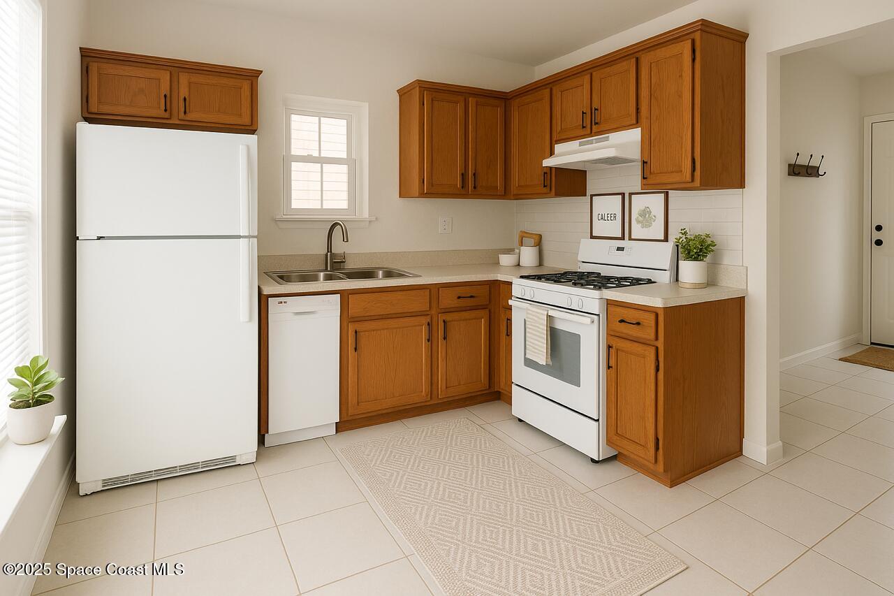 4533 Rivermist Drive Melbourne, FL 32935 - Photo 4 of 14 a kitchen with stainless steel appliances granite countertop a stove a sink and a refrigerator
