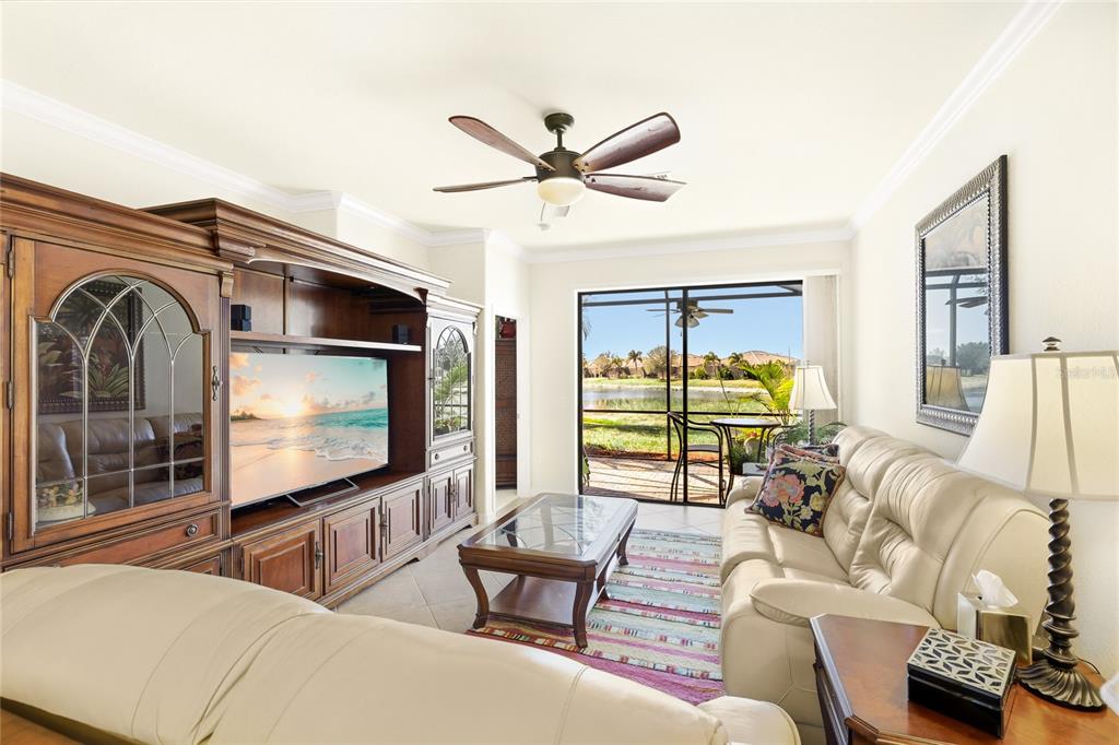 20209 Benissimo Drive Venice, FL 34293 - Photo 11 of 53 a living room with furniture and a flat screen tv