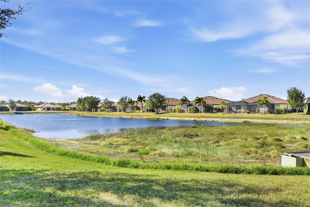 20209 Benissimo Drive Venice, FL 34293 - Photo 23 of 53 a view of a lake with houses in the back